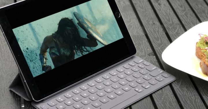 Girl swimming underwater on tablet screen, with Bali Stay beach resort theme.