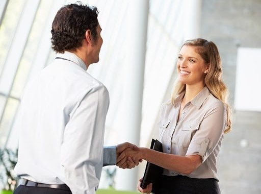 Elegant resort staff handshake at Bali Stay - Step Into The Beach Resort, tropical vacation, luxury accommodations.