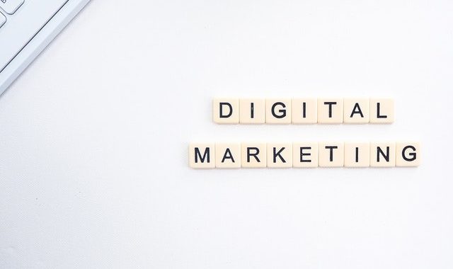 Digital marketing words spelled with letter tiles on a white background.